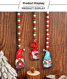 Three-piece set of wooden Christmas gnome pendants with red and green beads on a wall