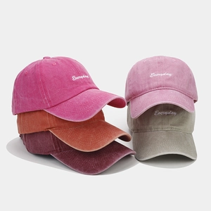Detailed stacked view of washed cotton baseball caps with Everyday cursive embroidery