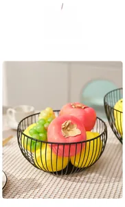 Close-up of black hollow metal fruit basket with breathable iron wire design for snacks