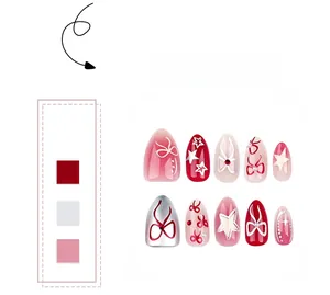 Detailed view of red and silver press-on nails with sweet bow and star patterns