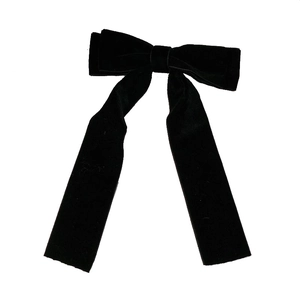 Elegant black velvet bow hair clip with long streamers on a clean white background