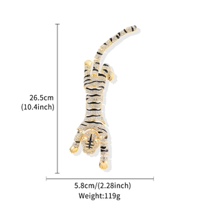 Detailed view of large crystal-embellished tiger brooch with black tiger stripes