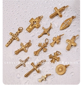 Detailed macro view of 18K gold plated stainless steel cross pendants and charms