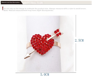 Detail view of heart-shaped napkin ring with red rhinestones and rose gold finish