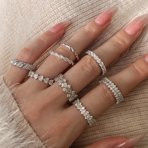 Close-up of S925 sterling silver stacked rings with heart and emerald-cut zircon stones