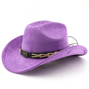 Detailed close-up of a bronze bull head emblem on a purple suede western cowboy hat