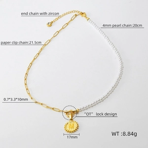 Detail view of pearl and paperclip chain necklace with OT lock and letter M pendant
