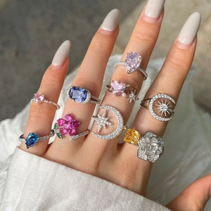 Detailed view of layered S925 sterling silver rings with colorful zircon heart and star