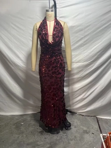 Detail of red sequin halter evening gown with deep V-neckline and slim-fit maxi silhouette