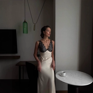 Ivory satin maxi dress with black lace trim and backless design for a stylish look