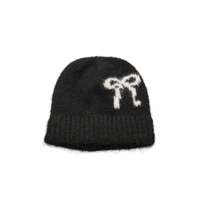Fuzzy knit beanie with white plush bow pattern for winter warmth and fashion