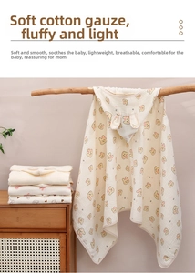 Detail of hooded baby poncho towel in soft cotton gauze with cute bear print pattern