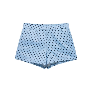 Detail of light blue mini shorts with black polka dots featuring a clean tailored waist