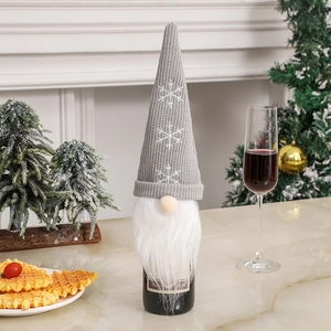 Detail of Christmas gnome wine bottle cover with grey knit hat and snowflake embroidery