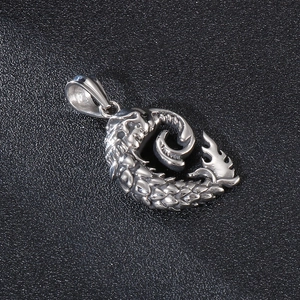 Gothic 925 sterling silver dragon pendant with intricate scales on a dark textured surface