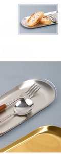 Detail of gold and silver oval stainless steel trays with smooth safe-edge design