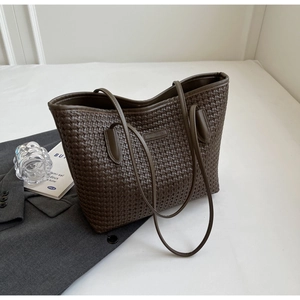 Detailed close-up of dark brown woven texture on a large capacity PU leather tote bag