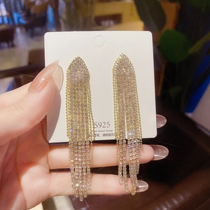 Close-up of S925 silver needle long tassel earrings with sparkling rhinestones in gold