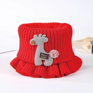Detailed close-up of a red knitted baby neck warmer with a cute 3D giraffe design