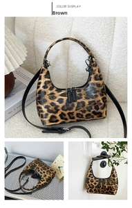 Close-up of leopard print handbag with glossy finish and double zipper design