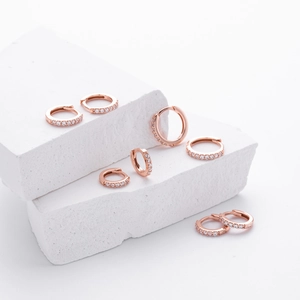 Detailed view of S925 sterling silver rose gold huggie earrings set with zircon stones