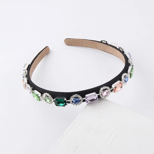 Detail of colorful rhinestones and velvet sponge headband with vintage jewels
