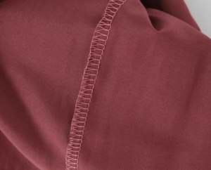 Detailed close-up showing the professional stitching and smooth texture of the burgundy fabric