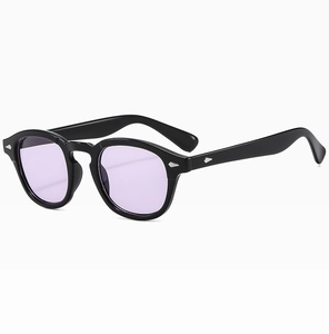Detail of round vintage sunglasses with purple lenses and silver diamond rivets