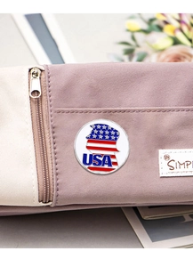 Detail of USA enamel pin with flag pattern on a fabric case in professional close-up view