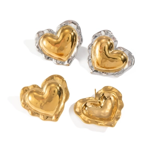 Detailed view of 18K gold heart earrings with ruffled silver edges on a white backdrop
