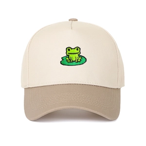 Detailed close-up of green frog on lily pad embroidery on bicolor baseball cap
