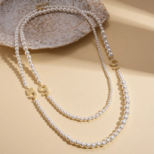 Elegant multi-layer faux pearl necklace with sparkling gold number 5 pendant accents