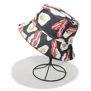 Black bucket hat with bacon and egg print on metal stand for sun protection