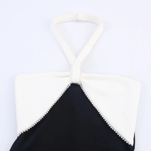 Black and white halter neck dress with contrast panels and elegant pearl bead trim