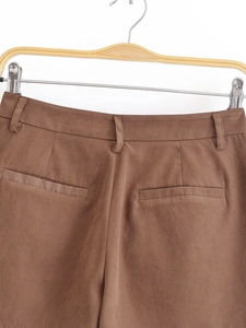 Detailed back view of brown casual trousers showing waistband and classic rear pockets