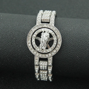 Close-up of iced-out silver metal bracelet featuring spinning religious Jesus emblem