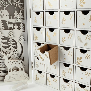 White wooden Christmas advent calendar with LED laser-cut reindeer and 24 numbered drawers