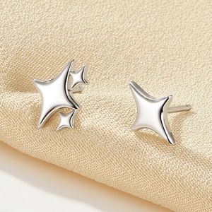 Macro view of 925 sterling silver star stud earrings with polished metallic luster