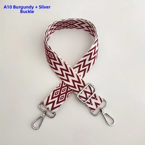 Close-up of wine red and white wave pattern wide adjustable shoulder strap with silver hooks