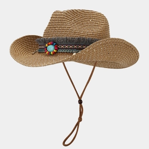 Detail of woven straw cowboy hat featuring ethnic beads, turquoise stone and tassels