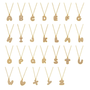 26 gold-plated stainless steel letter and heart pendants with zircon pave in grid layout