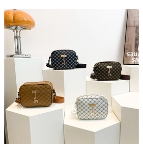 Detail of stylish leather crossbody bags in four colors with gold deer pendants