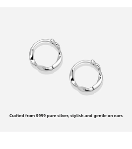 Macro detail of S999 sterling silver Mobius earrings with twisted texture finish