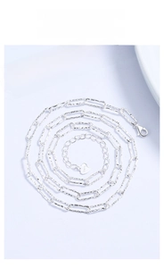 Detail of 925 sterling silver paperclip chain with heart charm and lobster clasp