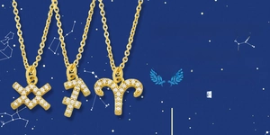 Detail of three zodiac necklaces in gold finish with cubic zirconia pavé pendants