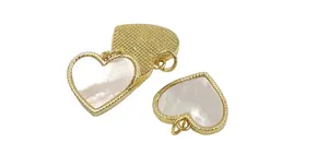 Detailed view of heart-shaped shell charms with gold beaded edges and iridescent luster