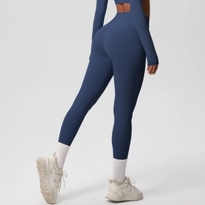 Detail view of high-waist navy blue yoga leggings with matte finish and compression fit