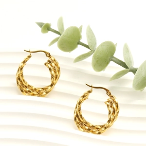 Detailed close-up of 18K gold-plated twisted hoop earrings with elegant minimalist texture