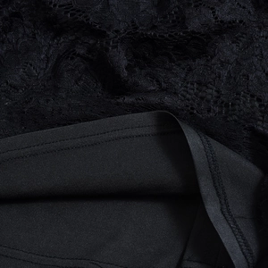 Detail view of black floral lace fabric with soft inner lining for backless maxi dress