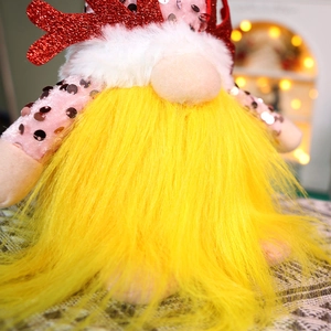 Detail of sequined Christmas gnome with Rudolph antlers and yellow plush beard decoration